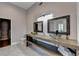 This bathroom features a double vanity with glass vessel sinks, modern fixtures, and a walk-in closet at 9440 Knollcrest Blvd, Alpharetta, GA 30022