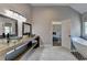 This bathroom features a double vanity with vessel sinks, a soaking tub, and modern fixtures at 9440 Knollcrest Blvd, Alpharetta, GA 30022