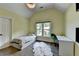 This bedroom offers a vaulted ceiling, wood floors, a large window, and a light fixture at 9440 Knollcrest Blvd, Alpharetta, GA 30022