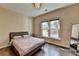 Bright bedroom with hardwood floors, a large window with yard views, and stylish modern furniture at 9440 Knollcrest Blvd, Alpharetta, GA 30022