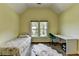 This bedroom features a vaulted ceiling, wood floors, a large window, and a modern desk and chair at 9440 Knollcrest Blvd, Alpharetta, GA 30022