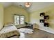 Cozy bedroom featuring a twin bed, stylish shelving and decor, and a study area with a window view at 9440 Knollcrest Blvd, Alpharetta, GA 30022