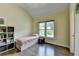 This bedroom has wood floors, a large window, and a neutral color palette for a tranquil feel at 9440 Knollcrest Blvd, Alpharetta, GA 30022