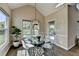 Cozy breakfast nook featuring large windows, hardwood floors, views of the yard, and modern lighting at 9440 Knollcrest Blvd, Alpharetta, GA 30022