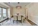 View of the dining room, displaying hardwood floors, natural light, and a modern chandelier at 9440 Knollcrest Blvd, Alpharetta, GA 30022