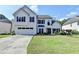Charming two-story home featuring a well-manicured lawn, white painted brick, and a two-car garage at 9440 Knollcrest Blvd, Alpharetta, GA 30022