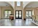 Elegant foyer with high ceilings, beautiful hardwood floors, and large windows at 9440 Knollcrest Blvd, Alpharetta, GA 30022