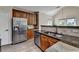 The kitchen features stainless steel appliances, wood cabinets, stone countertops, and a tiled backsplash at 9440 Knollcrest Blvd, Alpharetta, GA 30022