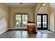 View of the living room displaying gleaming hardwood floors, large windows, and a high ceiling at 9440 Knollcrest Blvd, Alpharetta, GA 30022