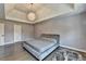This main bedroom offers a luxurious velvet platform bed and a stunning tray ceiling with an elegant light fixture at 9440 Knollcrest Blvd, Alpharetta, GA 30022