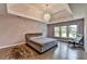 Spacious main bedroom with hardwood floors, a trey ceiling, modern furniture, and abundant natural light at 9440 Knollcrest Blvd, Alpharetta, GA 30022