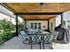 Charming covered patio featuring a dining set and hanging swing, perfect for outdoor enjoyment and relaxation at 9440 Knollcrest Blvd, Alpharetta, GA 30022