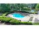 Inviting community pool surrounded by lounge chairs, perfect for relaxation and recreation in a serene setting at 9440 Knollcrest Blvd, Alpharetta, GA 30022