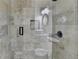 Close-up of a modern tiled shower with glass door and black hardware at 9440 Knollcrest Blvd, Alpharetta, GA 30022