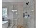 This bathroom has a modern glass shower with stone-look tile, a rain shower head, and a bench at 9440 Knollcrest Blvd, Alpharetta, GA 30022