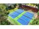 Aerial view of neighborhood tennis courts; an amenity for residents at 9440 Knollcrest Blvd, Alpharetta, GA 30022