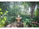 Picturesque backyard featuring a water fountain and landscaping, offering a serene and tranquil outdoor space at 176 Oakland Way, Dallas, GA 30157