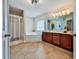 Bright bathroom featuring tile floor, tub, standalone shower, and double vanity with great storage at 176 Oakland Way, Dallas, GA 30157