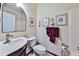 Cozy bathroom features a vanity, toilet, framed art, and tiled shower, creating a functional and stylish space at 176 Oakland Way, Dallas, GA 30157