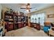 Organized home office area with a desk, large bookshelves, and window, complete with a ceiling fan at 176 Oakland Way, Dallas, GA 30157