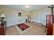 Neutral bedroom with standard closet, open doorway and traditional styled red carpet at 176 Oakland Way, Dallas, GA 30157