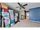 Bedroom with blue accent wall, ceiling fan and natural light at 176 Oakland Way, Dallas, GA 30157
