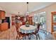 Charming dining area adjacent to the kitchen features a decorative chandelier and access to the outdoors at 176 Oakland Way, Dallas, GA 30157