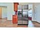 Kitchen with stainless steel fridge, wooden cabinets, and hardwood floors at 176 Oakland Way, Dallas, GA 30157