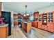 Spacious kitchen with wooden cabinets, an island, modern appliances, and hardwood floors at 176 Oakland Way, Dallas, GA 30157