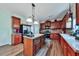Kitchen with dark wood cabinetry, tiled backsplash, stainless appliances, and an island at 176 Oakland Way, Dallas, GA 30157