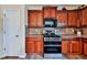 Kitchen with wooden cabinets, stainless steel oven, and matching appliances at 176 Oakland Way, Dallas, GA 30157