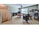 Cozy living area with a ceiling fan, ample natural light from the large window, and a comfortable sitting area at 176 Oakland Way, Dallas, GA 30157
