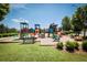Community playground with colorful slides, climbing structures, and soft ground cover, ideal for recreation at 176 Oakland Way, Dallas, GA 30157