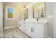 A bright bathroom featuring double sinks, black fixtures, and large mirrors at 2200 Upper Burris Rd, Canton, GA 30114