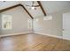 A bright bedroom with hardwood floors, vaulted ceiling, beams, and natural light from the windows at 2200 Upper Burris Rd, Canton, GA 30114