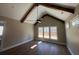 A large bedroom with vaulted ceilings, wood beams, and many windows that offer plenty of light at 2200 Upper Burris Rd, Canton, GA 30114