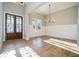 Elegant foyer boasts gleaming hardwood floors, a stylish chandelier, and a stunning wood double-door entry with decorative glass at 2200 Upper Burris Rd, Canton, GA 30114