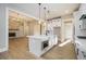 A modern kitchen with white cabinetry, an island with a microwave, and hardwood floors at 2200 Upper Burris Rd, Canton, GA 30114