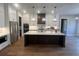 Stylish kitchen features white cabinets, a large island with marble countertop, stainless steel appliances, and pendant lighting at 2200 Upper Burris Rd, Canton, GA 30114