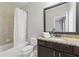Well-lit bathroom features a shower-tub combo and stylish vanity with granite countertop at 2828 Broughton Se Ln, Atlanta, GA 30339