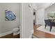 Cozy half bathroom featuring a toilet and eye-catching abstract artwork at 2828 Broughton Se Ln, Atlanta, GA 30339