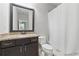 Bathroom featuring a shower-tub combo and vanity with granite countertop at 2828 Broughton Se Ln, Atlanta, GA 30339