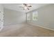 Spacious bedroom with neutral carpet, ceiling fan, and bright windows at 2828 Broughton Se Ln, Atlanta, GA 30339