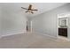 Large bedroom with carpet, ceiling fan, and an attached bathroom and closet at 2828 Broughton Se Ln, Atlanta, GA 30339