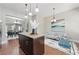 Open kitchen with island, hardwood floors, and view to dining and living areas at 2828 Broughton Se Ln, Atlanta, GA 30339