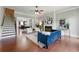 Inviting living room featuring hardwood floors, fireplace, and staircase with stylish furniture at 2828 Broughton Se Ln, Atlanta, GA 30339