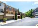 Townhomes with attached garages line the street with mature trees and landscaped yards at 2828 Broughton Se Ln, Atlanta, GA 30339