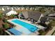 Aerial view of the neighborhood pool and clubhouse with ample seating and surrounding homes at 3351 Orwell Way # 2305, Cumming, GA 30041