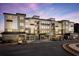 Exterior of a modern apartment building featuring stone accents, balconies, and covered parking at 3351 Orwell Way # 2305, Cumming, GA 30041