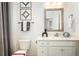 Bathroom with modern vanity, decorative accents, and framed mirror, with stylish gray and white motif at 3351 Orwell Way # 2305, Cumming, GA 30041